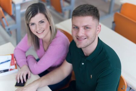 Two young economy students analyzing company annual financial report balance and prepairing for...