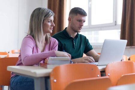 Two young economy students analyzing company annual financial report balance and prepairing for...