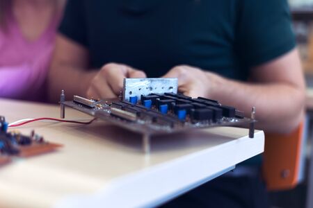 Scientists engineers designing small human robot, setting artificial intelligence humanoid robot....