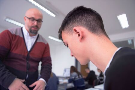 Male Professor Holding Lecture to Multi Ethnic Group of Students. Smart Young People Studying at the University.の写真素材
