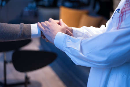 Arab Businessmen's Handshake with American Businessman Descent. Confirmation of Business alliance Partners as WELL. Adhering Respect, Commitment and Integrity in Business Partnership Dealの写真素材