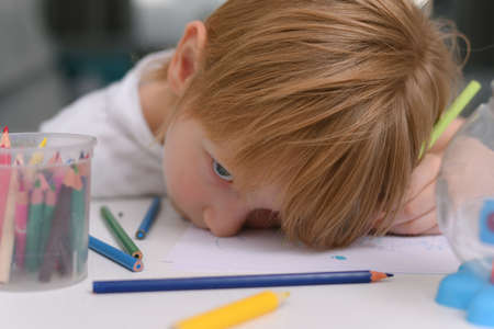Five years old boy with tablet and drawing tools. Distance online education with digital tablet and...