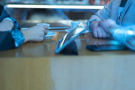 Startup Diversity Teamwork Brainstorming Meeting Concept.Two Business Coworkers discussing about Economy situation in their companies. People Working Planning Start Upand  Discussing inside Cafe bar.の写真素材