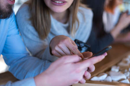Startup Diversity Teamwork Brainstorming Meeting Concept.Two Business Coworkers discussing about Economy situation in their companies. People Working Planning Start Upand  Discussing inside Cafe bar.の写真素材