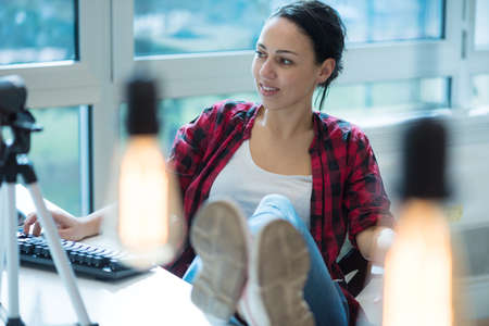 Attractive female blogger recording video for vlog. Gorgeous female coach and blogger giving...