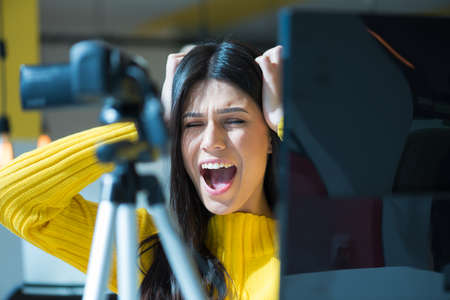 Attractive female blogger recording video for vlog. Gorgeous female coach and blogger giving...