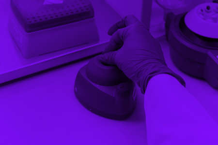 Young female Laboratory scientist working at lab with test tubes and microscope, test or research in clinical laboratory.Science, chemistry, biology, medicine and people concept.の写真素材