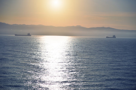 Summer cruise vacation concept. Panoramic view of the sea with a beautiful sunset just above the horizont.の写真素材