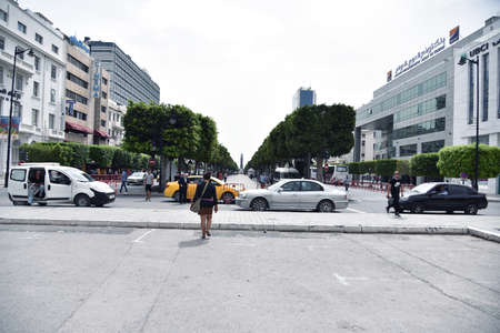 TUNIS, TUNISIA - JUNE  14, 2019: Street scene in downtown on Avenue Bourguiba near cathedral of St...
