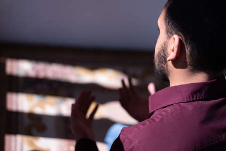 African Muslim Man Making Traditional Prayer To God. Religious black muslim man praying inside the mosque during ramadanの写真素材