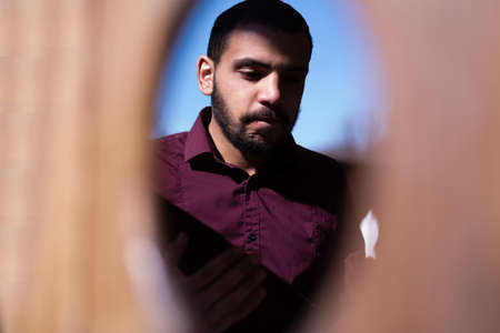 African Muslim Man Making Traditional Prayer To God. Religious black muslim man praying inside the mosque during ramadanの写真素材