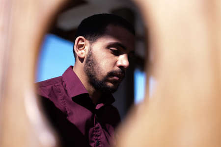 African Muslim Man Making Traditional Prayer To God. Religious black muslim man praying inside the mosque during ramadanの写真素材