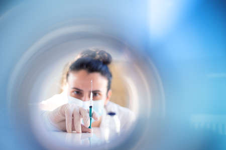 Nurse or female doctor prepairs anti vaccine dose for a patientの写真素材
