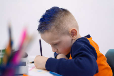 Distance learning and online education. Schoolboy boy studies at home and does school homework. Remote learning during  pandemicの写真素材