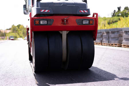 Urban road asphalting works. Asphalt paving. Paver machine and road roller. New road construction.の写真素材