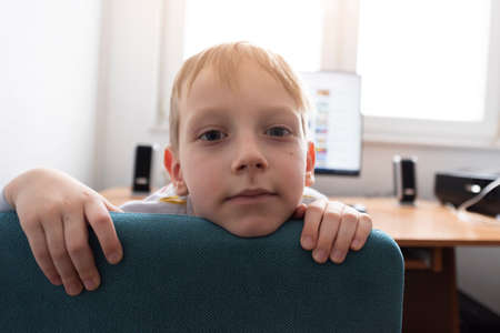 Young  boy student video conference e-learning with teacher on computer in his room at home....