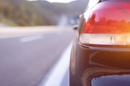 Black car stoed and parked on highway road. Roadside assistance concept