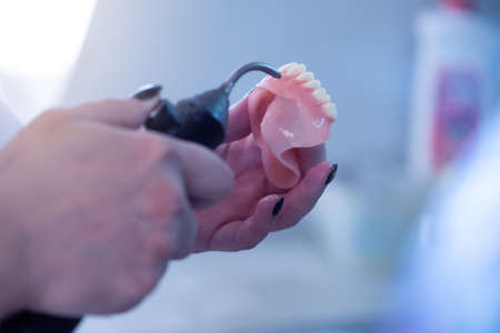 Dental prosthesis, dentures, prosthetics work. A study and a table with dental tools