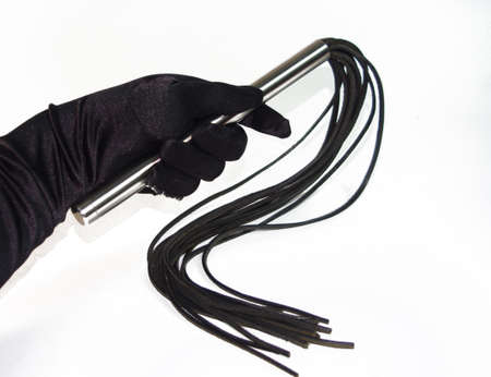 Black fetish flogging whip in woman hand