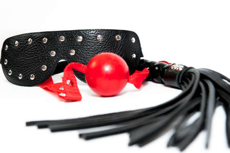 Black mask, ballgag and flogging whipの写真素材