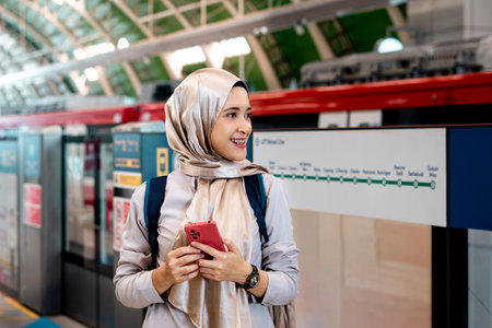 Asian muslim woman on subway train transit system public. Public transport concept