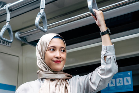 Asian muslim woman on subway train transit system public. Public transport conceptの写真素材