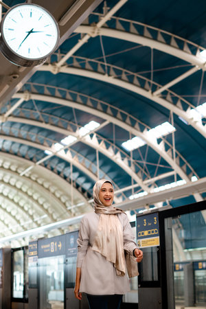 Asian muslim woman on subway train transit system public. Public transport concept