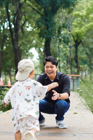 Father and Son Bonding and having a Playful Day Out in the Park. Father and son outdoor play conceptの写真素材