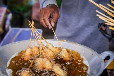 Cilor or Cilung, Indonesian traditional street food being fried.の写真素材