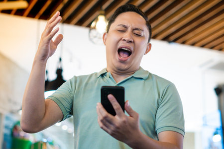 Adult man Angry and shocked over something on his phone