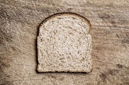 A slice of wholemeal bread on a table.の写真素材