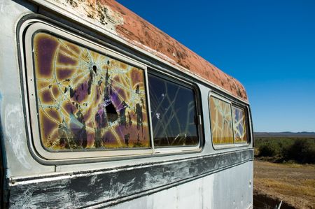 abandoned bus in the patagonian steppe with broken windows.の写真素材
