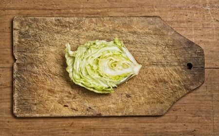 cut fresh lettuce on old wooden table.の写真素材