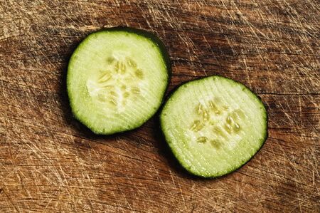 Slices of cucumber on a wooden background.の写真素材