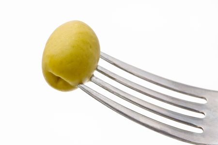 Fresh green olive in a fork, white background.の写真素材
