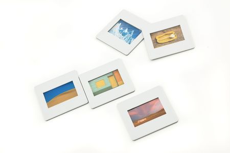 Five color slides with plastic frames on llightbox, close up.の写真素材