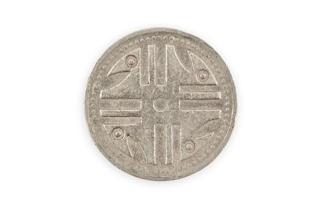 Close-up of a colombian coin with indigenous Quimbaya civilization figurine