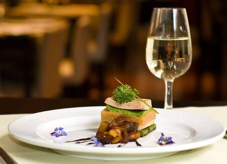 Gourmet dish and white wine, restaurant.の写真素材