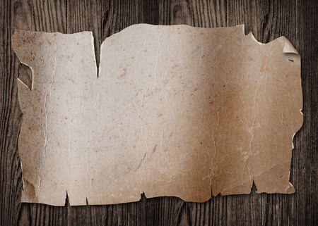 Old paper sheet on a wooden surface.の写真素材