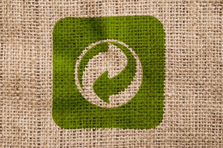 Rough old canvas with green recycle sign.の写真素材