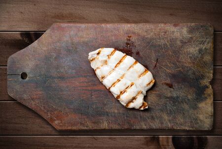Grilled chicken breast on wooden table.の写真素材