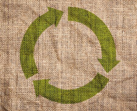 Rough old canvas with green recycle sign. の写真素材