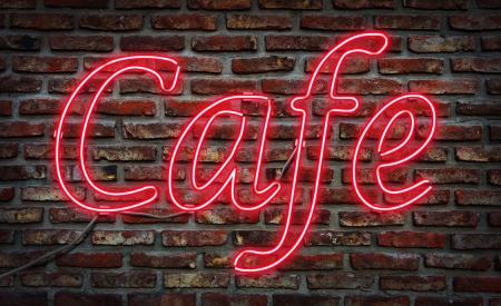 Glowing neon Cafe sing on a brick wall の写真素材
