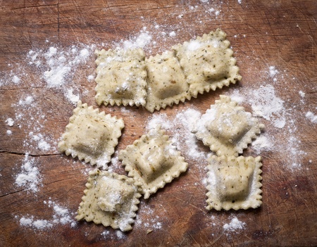 Raw  homemade ravioli on wooden table.の写真素材