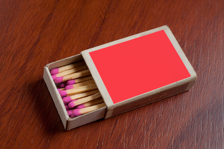 Red Match box on wooden table.の写真素材