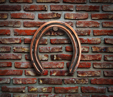 Horseshoe hanging on brick wall.の写真素材