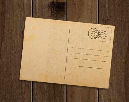 Old postcard, on wooden table.の写真素材