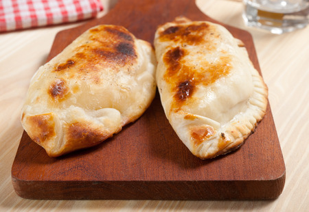 Argentine empanadas on wooden table.の写真素材