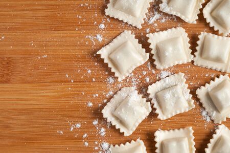 Freshly Made Homemade Ravioli on wooden table.の写真素材