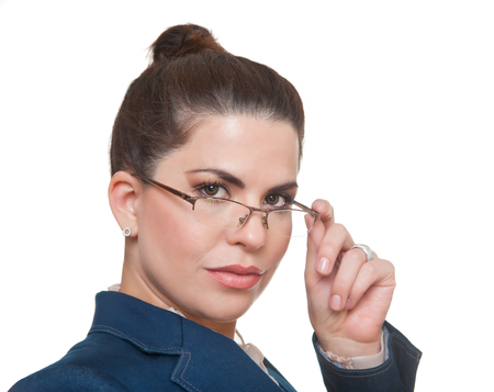 Beautiful, serious  businesswoman  wearing glasses and a formal office suit, looking at camera.の写真素材